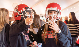 two students wearing football helmets