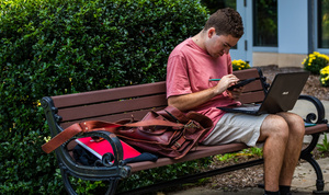 Student studying on bench